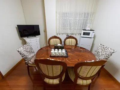 a dining room table with chairs and a chessboard on it at Koka House TOKYO ASAKUSA in Tokyo