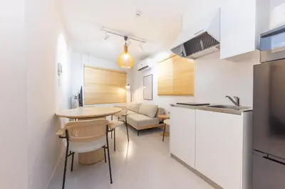 a kitchen and living room with a table and chairs at \u30e1\u30be\u30f3\u30a2\u30eb\u30c7\u30d0\u30e9\u30f3 in Tokyo