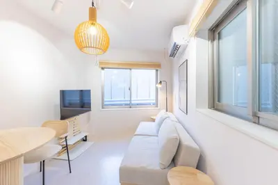 a living room with a couch and a table at \u30e1\u30be\u30f3\u30a2\u30eb\u30c7\u30d0\u30e9\u30f3 in Tokyo