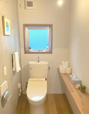 a bathroom with a white toilet and a window at Sunshine in Tokyo