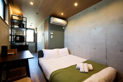 a bedroom with a bed with two towels on it at Life Town Oshiage - Compact Stay - Steps from Skytree in Tokyo