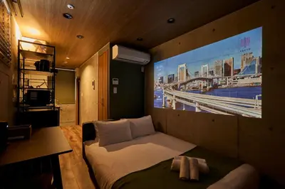 a bedroom with a bed and a large painting on the wall at Life Town Oshiage - Compact Stay - Steps from Skytree in Tokyo