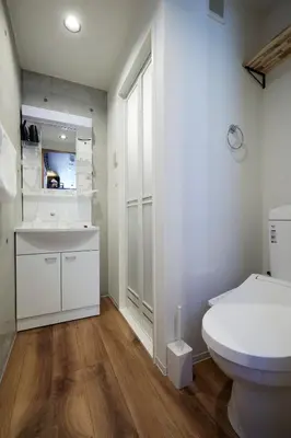 a white bathroom with a toilet and a sink at Life Town Oshiage - Compact Stay - Steps from Skytree in Tokyo