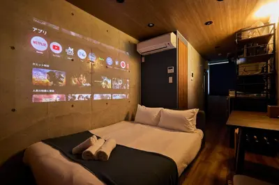 a bedroom with a bed with two towels on it at Life Town Oshiage - Compact Stay - Steps from Skytree in Tokyo
