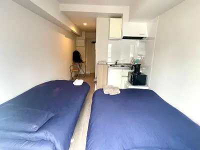 a small room with a bed and a kitchen at West Shinjuku Entire House with 2beds in Tokyo
