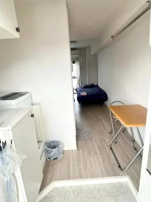 a small room with a table and a blue suitcase at West Shinjuku Entire House with 2beds in Tokyo