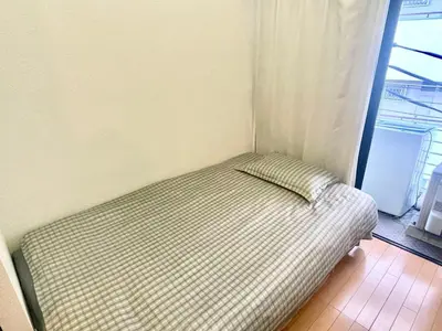 a small bed in a room with a window at West Shinjuku Entire House with 2beds in Tokyo