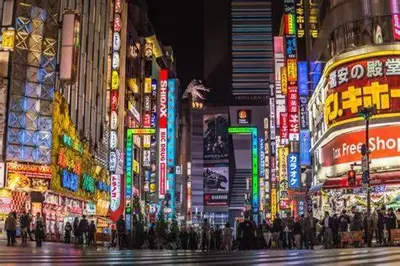 a crowd of people crossing a city street at night at West Shinjuku Entire House with 2beds in Tokyo