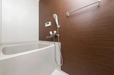 a shower with a hose attached to a wooden wall at PremiumStay Komagome in Tokyo