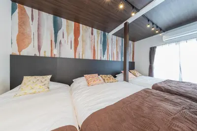two beds sitting next to each other in a room at PremiumStay Komagome in Tokyo