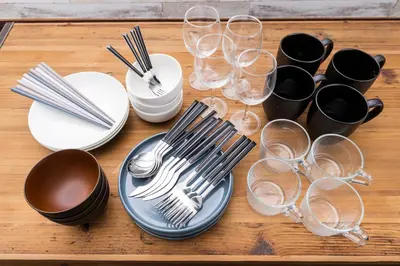 a table with plates and wine glasses on it at PremiumStay Komagome in Tokyo