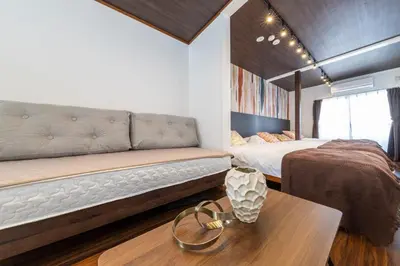 a living room with a couch and a bed at PremiumStay Komagome in Tokyo