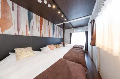 a bedroom with two beds and a painting on the wall at PremiumStay Komagome in Tokyo