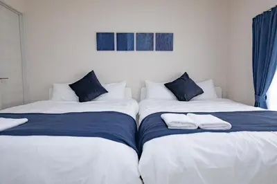 two beds sitting next to each other in a bedroom at iine house hatagaya in Tokyo
