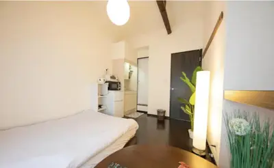 a hotel room with a bed and a table at iine house hatagaya in Tokyo