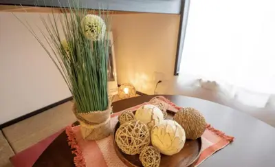 a table with a vase and some shells on it at iine house hatagaya in Tokyo