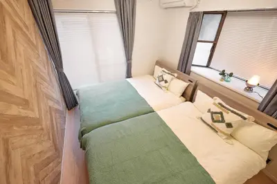 a small bedroom with a bed and a window at Simple Stay ShibuyaShinjyuku in Tokyo