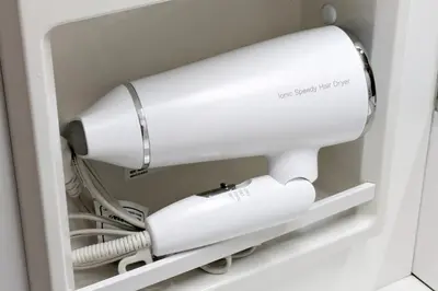 a white blow dryer in a room at Simple Stay ShibuyaShinjyuku in Tokyo