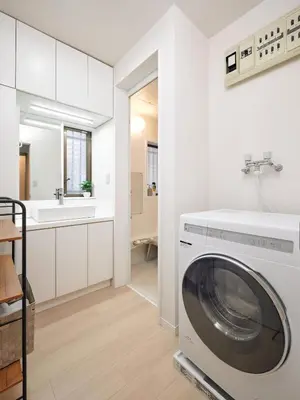 a white laundry room with a washing machine at Simple Stay ShibuyaShinjyuku in Tokyo