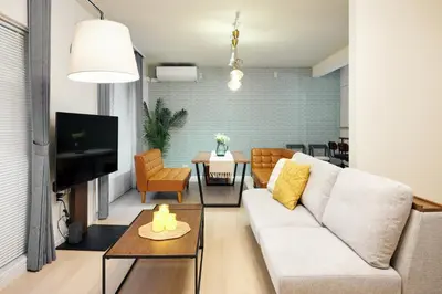 a living room with a couch and a table at Simple Stay ShibuyaShinjyuku in Tokyo