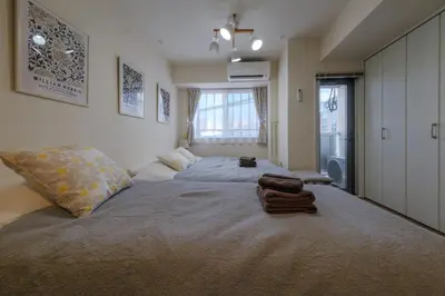 a bedroom with a large bed with towels on it at 5min Tachiaigawa Station Max 4 Haneda 17min in Tokyo