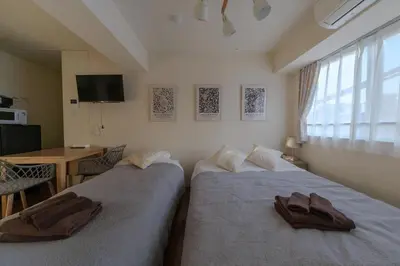 two beds in a hotel room with towels on them at 5min Tachiaigawa Station Max 4 Haneda 17min in Tokyo