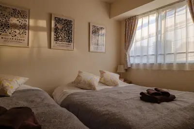 a bedroom with two beds and a window at 5min Tachiaigawa Station Max 4 Haneda 17min in Tokyo