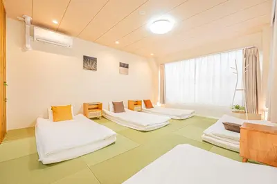 a room with three beds and a window at Mori hotel Akihabara 1 in Tokyo