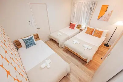 a small living room with two beds and a couch at Mori hotel Akihabara 1 in Tokyo