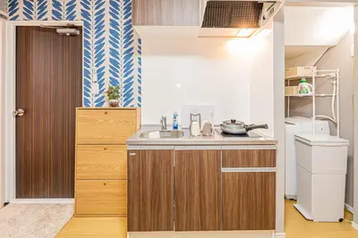 a small kitchen with a sink and a refrigerator at Mori hotel Akihabara 1 in Tokyo