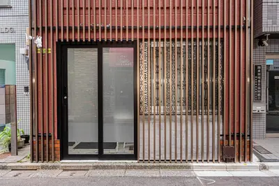 a building with a glass door on a street at Mori hotel Akihabara 1 in Tokyo