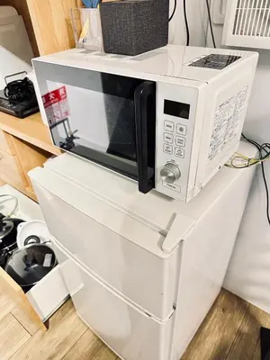 a microwave sitting on top of a white refrigerator at Hotel Axel Shinjuku in Tokyo