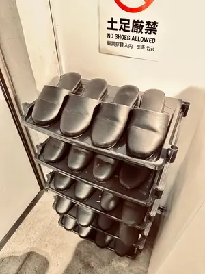 a row of shoes on a rack in a store at Hotel Axel Shinjuku in Tokyo