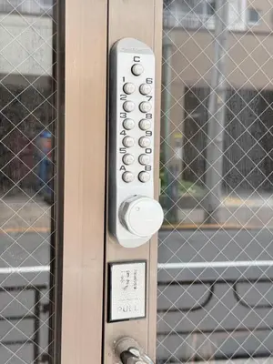 a remote control on a door with a window at househotel\u4e0a\u91ce \u5165\u8c37 in Tokyo