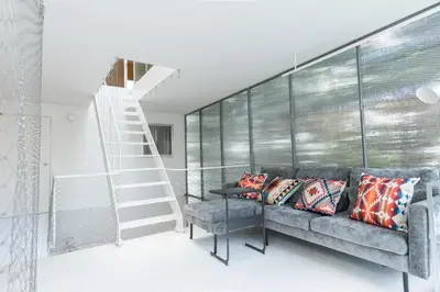 a living room with a couch and a staircase at \u6c60\u888b\u8fd1\u304f\u5e83\u3005\u5feb\u9069\u306a\u4e00\u8ed2\u5bb6unbound in Tokyo
