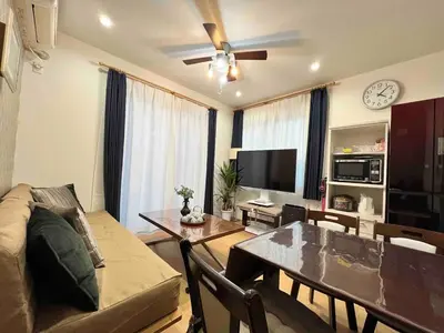 a living room with a couch and a table at Fit-Inn Komagome JR Line and Komagome 2 min walk Direct access to Shinjuku Ikebukuro Shibuya Akihabara Ueno in Tokyo