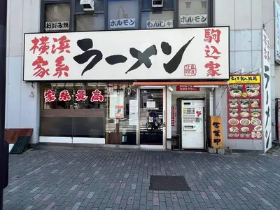 a store with signs on the front of a building at Fit-Inn Komagome JR Line and Komagome 2 min walk Direct access to Shinjuku Ikebukuro Shibuya Akihabara Ueno in Tokyo