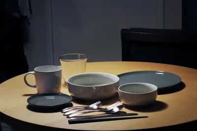 a table with three plates and two cups and utensils at Kitohana Oshiage in Tokyo