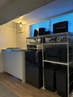 a kitchen with a counter and a microwave oven at Kitohana Oshiage in Tokyo