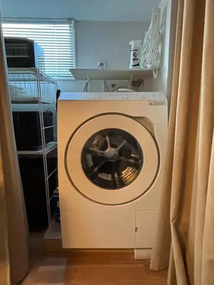 a washing machine with its door open in a room at Kitohana Oshiage in Tokyo