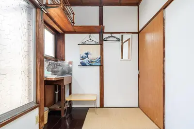 a hallway with a door and a chair and a table at \u30b9\u30de\u30a4\u30eb\u30cf\u30a6\u30b9 in Tokyo