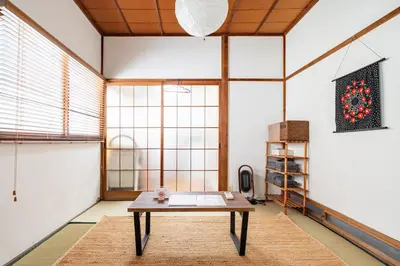 a room with a table in front of a large window at \u30b9\u30de\u30a4\u30eb\u30cf\u30a6\u30b9 in Tokyo