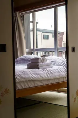 a mirror reflection of a bed in a room with a window at Bright Park House in central Tokyo in Tokyo