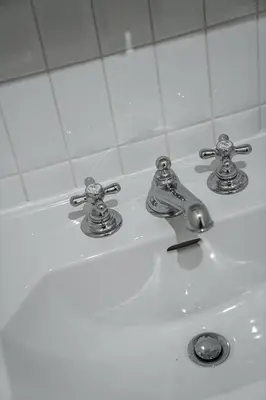 a bathroom sink with two faucets on it at Bright Park House in central Tokyo in Tokyo