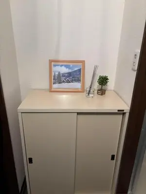 a white cabinet with a picture on top of it at \u5409\u5c4b-\u65b0\u5bbf in Tokyo