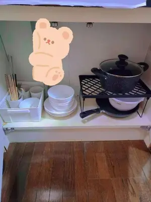 a shelf with dishes and a pot and a pan at \u5409\u5c4b-\u65b0\u5bbf in Tokyo