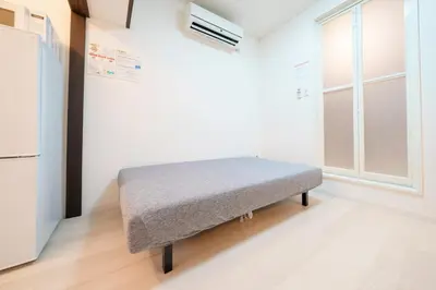 a bench in a room with a window at Sakura House Meguro in Tokyo