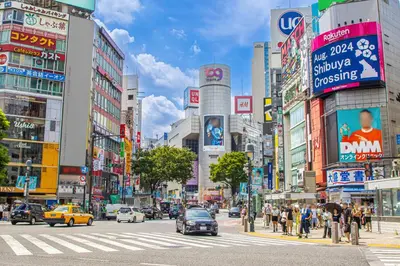 a busy street in a busy city with cars and people at Sakura House Meguro in Tokyo
