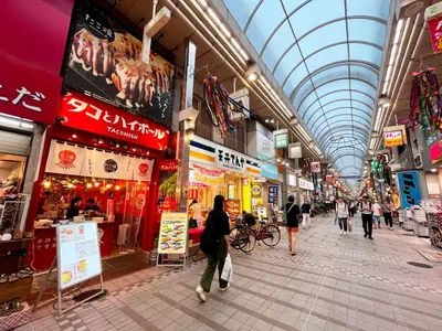people walking through a shopping mall with a glass ceiling at Sakura House Meguro in Tokyo