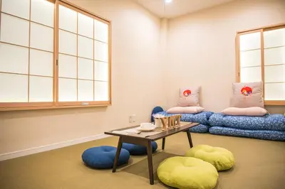 a room with a table and two bean chairs and a table sidx sidx at \u548c\u306e\u5bbf\u30db\u30c6\u30ebYamatoinn Akihabara#101 in Tokyo